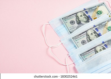 Blue Medical Masks And Dollars On Pink.Helping Poor Countries With Money And Masks.Penalty For No Wearing Masks.Cash Payments To Doctors.Expensive Hospital Services.Sponsoring Medical Research.