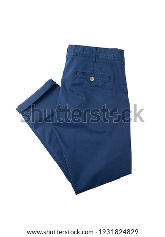 Blue men's trousers stacked on a white isolated background. Chinos. Clothing shopping theme. View from above.