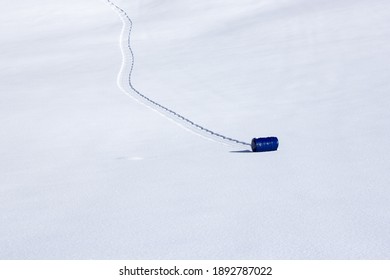 Blue Metal Barrel Rolling Downhill In The Snow