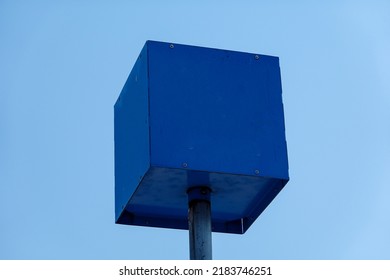 Blue metal box on a metal pole with a clear blue sky background