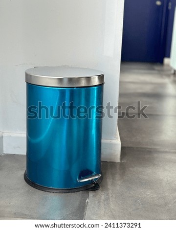 blue metal dustbin with pedal