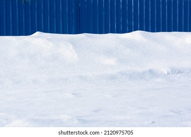 Blue Metal Fence And Snow.