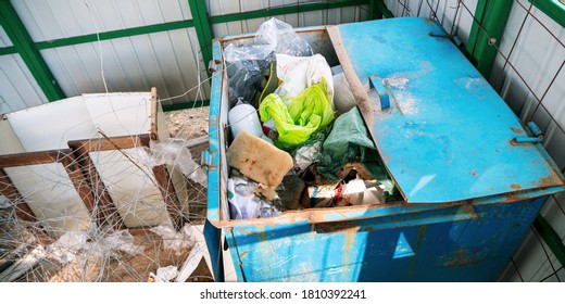 Blue Metal Garbage Bin With Plastic Trash Overhead View Closeup