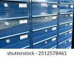 Blue metal mailboxes with apartment numbers in an apartment building. High quality photo