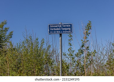 Blue Metal Plate That Says Gevaarlijk Terrein, Verboden Toegang. Art. 461 Htb. Van Strafrecht In Dutch Which Means: Dangerous Terrain, No Trespassing. Article 461 Law. Criminal Law