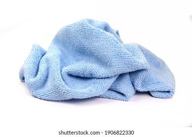 Blue micro fiber towel isolated on white background. Clean, new blue microfiber cloth isolated on white background