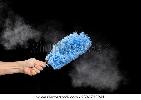 Blue microfiber Duster stick made from synthetic to clean house dust and web. Room Ceiling and window covered with dust bunnies, cobweb cleaned by microfiber duster stick. Black background isolated