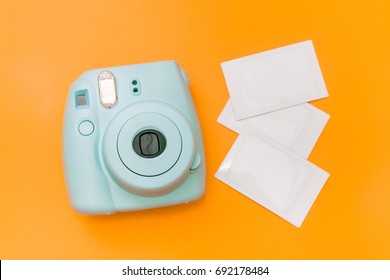 Blue mint instant camera with film - Shutterstock ID 692178484