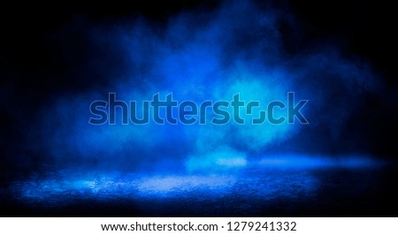 Blue misty dark background. Dark street with smoke, fog, blue spotlights, neon. Dark abstract empty background.