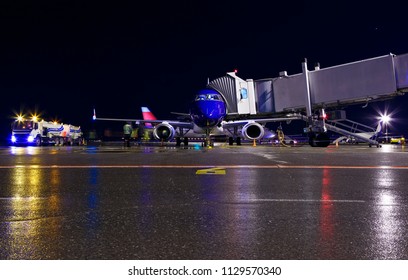 Blue Modern Aircraft Maintenance Night Airport Of Yekaterinburg , Fuel Truck, Jet Bridge And The Staff People