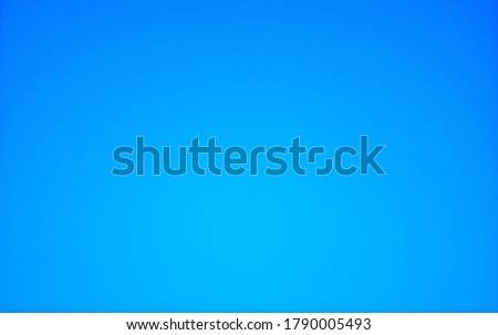 Blue monochrome background with gradient and vignetting around the edges. Close-up, texture.
