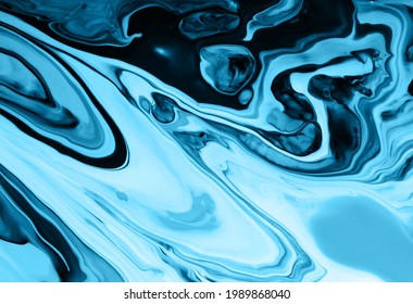 Blue monochrome marble abstract background.Make up concept.Beautiful stains of liquid nail lacquers.Fluid art,pour painting technique.Good as digital decor,copy space.