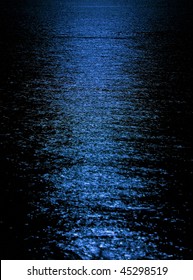 Blue moon light reflection on calm but rippled water