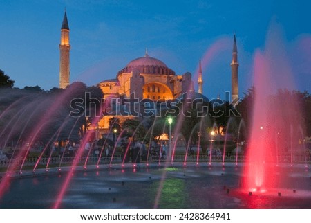 The blue mosque (sultan ahmet camii) with domes and minarets, fountains and gardens in foreground, floodlit at night, sultanahmet, central istanbul, turkey, europe