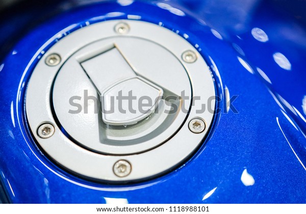 Blue motorcycle Oil filler cap. Fuel tank flap\
shape. Close-up.