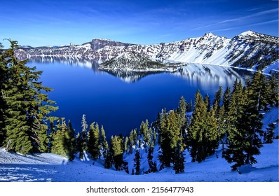 Blue mountain lake in winter. Winter mountain lake landscape. Lake in winter mountains. Winter snow scene on mountain lake