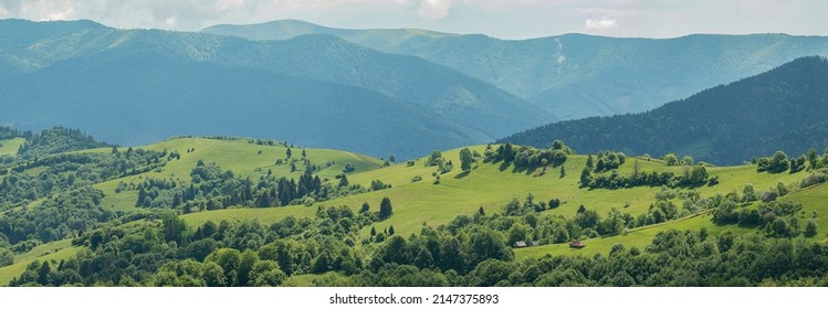 Blue mountains, green valley. Panoramic view of Ukrainian mountains in summer day. Carpathian, Ukraine, Europe. Mountain tourism. Tourism and travel concept. Natural green forest background panorama.  - Shutterstock ID 2147375893