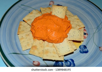 Blue Mountains, New South Wales, Australia. May 2019. Roasted Capsicum Dip And Crackers On A Blue Plate.