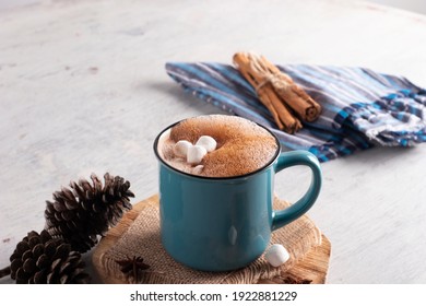 Blue mug with hot cocoa drink and mash mellows laid on vintage table - Shutterstock ID 1922881229