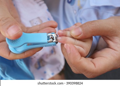 Blue Nail Clipper,fingernails Cut Of A Baby By Mother.