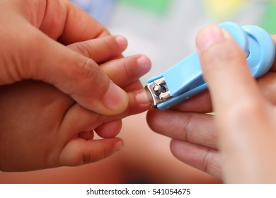 Blue Nail Clipper,fingernails Cut Of A Baby By Mother.