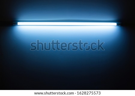 Blue neon lamp on a white wall