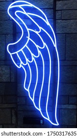 Blue Neon Light In An Angel Wing Shape On A Wall Background