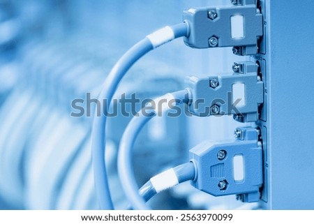 Blue network cables connected to server ports in data center.
