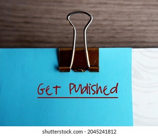 Blue note and document clip, with text written GET PUBLISHED,concept of book writer author must get their manuscript to be read by editors and published by publisher or self-publishing