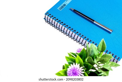 Blue Note Pad With Spiral And Pen Isolated On White Background