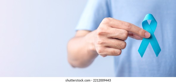 Blue November Prostate Cancer Awareness month, Man in blue shirt with hand holding Blue Ribbon for support people life and illness. Healthcare, International men, Father, Diabetes and World cancer day - Shutterstock ID 2212009443