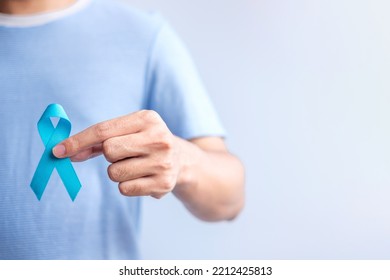 Blue November Prostate Cancer Awareness month, Man in blue shirt with hand holding Blue Ribbon for support people life and illness. Healthcare, International men, Father, Diabetes and World cancer day - Shutterstock ID 2212425813