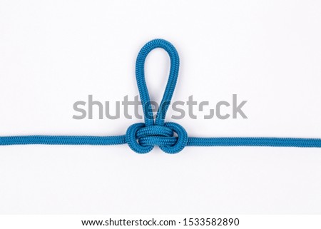 Blue nylon rope in alpine butterfly knot on white