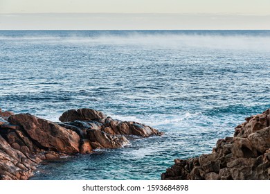 Blue Ocean With Band Of Mist Off Rugged Rocky Coast
