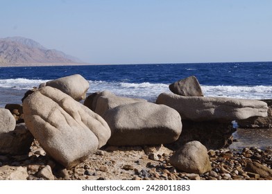 Blue Ocean with a Rocky Beach Shoreline - Powered by Shutterstock