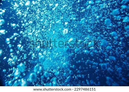 Blue ocean water with diving bubbles close up background