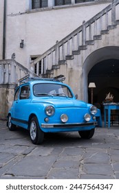 Blue Oldtimer infront of staircase of an old town