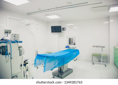 Blue operating table in an empty operating room.