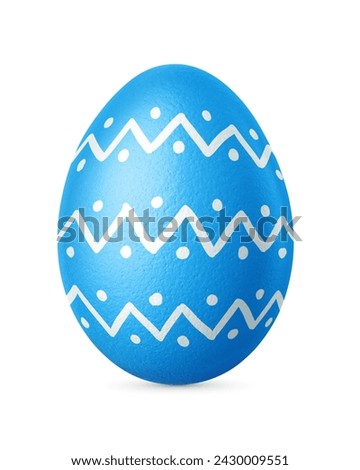 Blue ornate Easter egg isolated on a white background. Homemade painted Christian decoration.