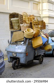 Blue Over-burdened Motor Scooter In Rome