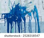 Blue paint splashed on the wall surface, wall paint mess.