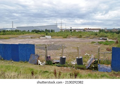 Blue Painted Timber Fencing Around Derelict Construction Site 