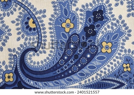 A blue paisley floral pattern in close up 