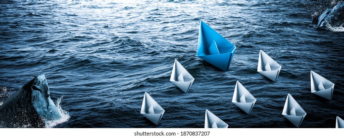 
Blue Paper Boat Leading A Fleet Of Small White Boats Around Rocks In Rough Water - Leadership Concept