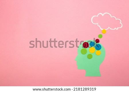 blue paper head with colorful dots leading to clouds as a space for copying, message, thinking, intelligent head, creative design, high cognitive abilities