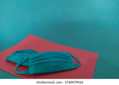 Blue Paper Mask. Blue Background. Origami 