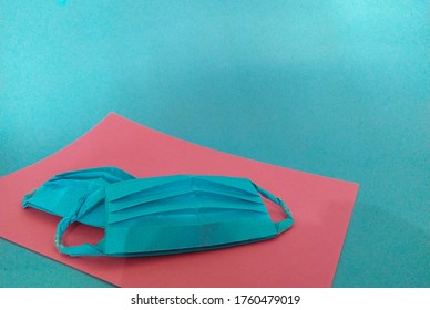 Blue Paper Mask. Blue Background. Origami 