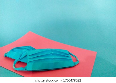 Blue Paper Mask. Blue Background. Origami 