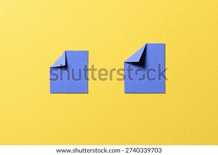 Blue paper message notes or sheets with folded edge dog-ear earmark and copy space for text on yellow background, top view flat lay conceptual desk backdrop