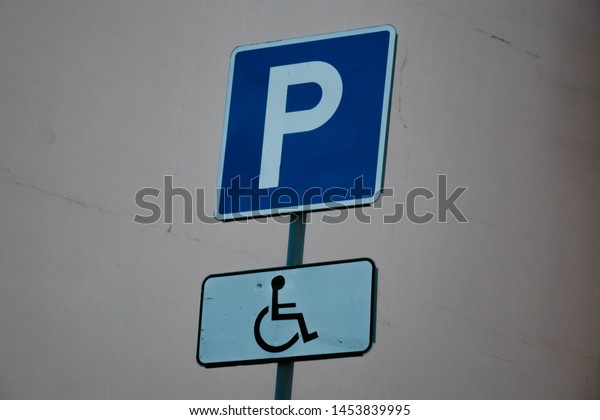 blue Parking sign with\
disabled sign.
